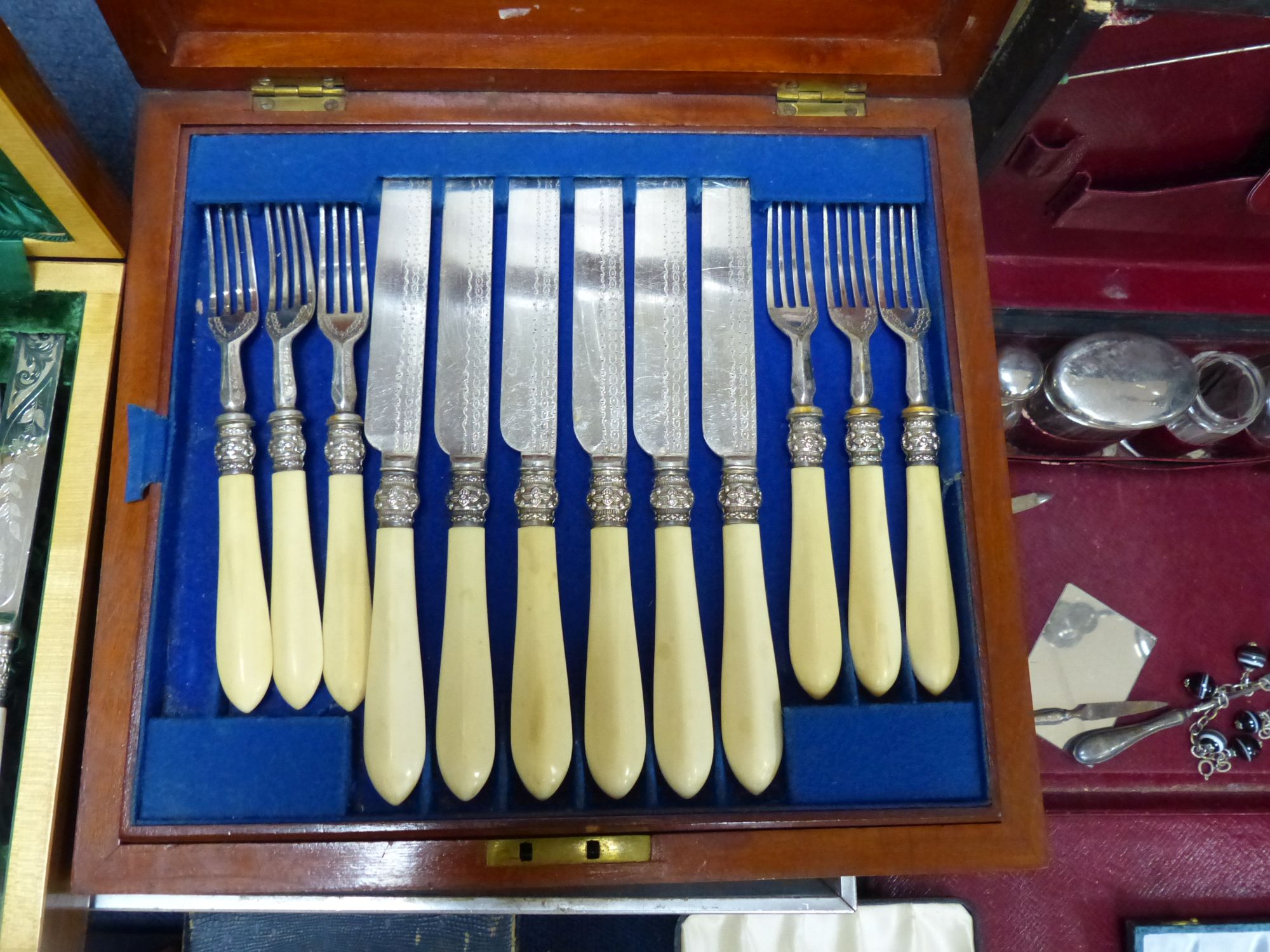 Eight assorted cased sets of silver plated cutlery including dessert eaters and a plated part toilet set.